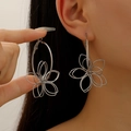 Close-up of oversized hollow flower earrings in silver finish showing size and fit - Silver Hollow Petal Earrings (07 White K 1872)