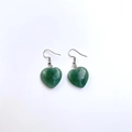 Macro detail of dark green heart-shaped stone pendant with silver hook earrings - Green Aventurine