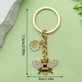 Bee and daisy keychain in gold finish with yellow enamel charms for bags - Daisy Pendant Style