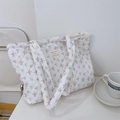 Macro detail of quilted cotton tote bag with delicate floral pattern and French label - Yellow and Pink Floral on White