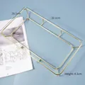 Rectangular golden metal wire storage tray with spherical feet on light blue background - Metal Display Rack-Rectangular Gold