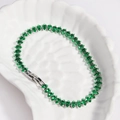 Macro detail of silver tennis bracelet featuring green marquise-cut zircon stones - Green Zircon - White Gold