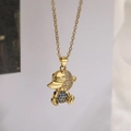 Macro shot of gold-plated teddy bear pendant with clear and blue crystals and COOL logo - Blue Bear Style(23652)