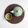 Celadon tea set with Xishi teapot and cup on oval bamboo placemat in minimalist style - Coffee Round 20cm