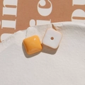 Macro shot of orange and white square resin beads for DIY jewelry making with smooth finish - Orange Square