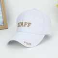 Detail of gold STAFF embroidery on the front of a minimalist white cotton baseball cap - White with Gold Letters