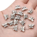 Silver vintage butterfly alloy spacer beads for DIY jewelry making on a hand - Butterfly / 11x8mm