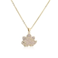 Macro shot of gold plated Stegosaurus pendant with purple zircon pavé and black eye detail - Gold Stegosaurus-Light Purple Zirconia(21268)