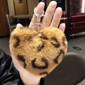 Brown leopard print heart-shaped plush keychain with silver ring held in hand - Coffee Leopard Heart Plush