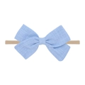 Close-up of blue linen bow on soft nylon baby headband with detailed fabric texture - Blue