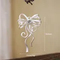 White frosted bow Christmas ornament with crystal center and subtle glitter finish - Bow