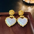 Macro shot of vintage gold flower and heart earrings with iridescent resin luster - Gold Flower Iridescent Heart Drop