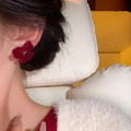 Elegant red flocked flower stud earring with black center gem worn on ear - Red Flocked Flower