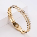 Gold zigzag wave bracelet with pavé rhinestones and spring clasp on white background - Gold