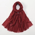 Close-up of deep red breathable cotton scarf showing woven texture and fringe details - Jujube Red