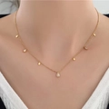Minimalist gold teardrop necklace for women with clear zircon stone pendants on model - Water Drop / Gold