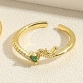 Detail of gold open ring featuring green heart gem and intricate dragon carving - Adjustable Open / Emerald Green Water Drop Zirconia