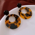 Detail of leopard print resin hoop earrings on a ceramic dish with fabric background - 57# Silver Needle - Brown - Round Dangle