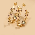 Exaggerated golden leaf vine hoop earrings set with elegant purple gemstones - Pink Zirconia Leaf