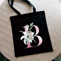 Bolso de lona negra con la letra B en degradado rosa y estampado de flor de lirio - Letra B / Negro