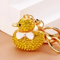Detailed macro view of yellow rhinestone duck keychain with a cute white bow and golden alloy ring - Yellow Full Rhinestone Duck