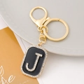Macro detail of alphabet J keychain with sparkling rhinestones and gold lobster clasp - Letter J