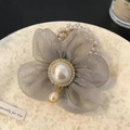 Detailed view of grey organza flower hair tie with rhinestones and pearl bead core - Gray