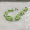 Detail of vibrant green acrylic chain link with frosted white accents and gold metal rings - Frosted Grass Green