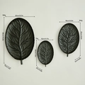 Set of three matte black leaf-shaped decorative metal trays in various sizes - Black