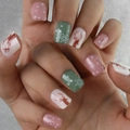 Detailed view of Christmas press-on nails with reindeer and snowflake patterns - Christmas Theme Pattern