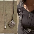 Detail of dollar sign pouch pendant on bead chain and woven mesh charm on black cord necklace - 104# Retro Silver Money Bag