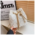 Close-up of white denim bucket bag with frayed quilted patterns and gold pearl chain - One Size / White
