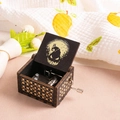 Macro shot of hand-crank wooden music box with Jack Skellington engraving and gold patterns - Halloween 1