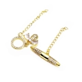 Detail of gold-plated bee and lipstick pendants with sparkling zircon stone inlays - Bee & Lipstick Style