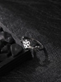 Macro detail of silver stainless steel ring featuring hollow flower pattern on dark stone - Plum Blossom Style (NR295)