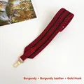 Detail of wide woven bag strap in burgundy and black with gold metal snap hooks - Wine Red with Wine Red Trim
