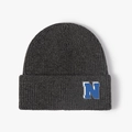 Dark gray ribbed knit beanie featuring a blue letter N patch for winter outdoor warmth - Dark Gray