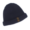 Detail of navy blue ribbed beanie featuring a sewn black label with gold lion emblem - Navy Blue