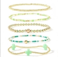 Five-piece stackable gold bead bracelet set with green crystals and a cross charm - Mint Green Gold 5-Piece Set