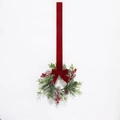 Close-up of Christmas wreath with pine needles, red berries, and velvet bow ribbon - Frosty White Large Round Antler Pine Needle Red Velvet Bow