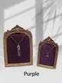 Macro shot of purple fringe and pendant necklaces in a vintage gold frame display - Purple