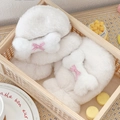 Plush white faux fur bone-shaped gloves with pink plaid bows for winter warmth - Bone Plush Style