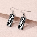 Detail view of rectangular leopard print earrings with silver frame on pink textured background - Black White Fashion Leopard (FXEH-27-9)