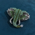 Vintage elephant brooch in silver finish with vibrant green and iridescent rhinestones - Vintage Colorful Rhinestone Elephant Head Brooch Green