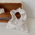 Detail of floral canvas tote bag featuring pink blossom patterns and a brand logo tag - Twill Floral Pink