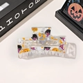 Macro view of transparent Halloween claw clip featuring black cat and pumpkin patterns - 8.5cm Transparent Square - Purple Hat Coal Ball