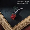 Detailed macro view of baroque rose brooch with red crystals and dimensions 2.5x4.6cm - Steel Silver Rose Flower