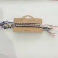 Detail of colorful woven bohemian bracelets with tassels on a branded card packaging - Dark-Colored Woven Bracelet Set