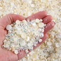 Macro shot of mixed white flatback pearls and sparkling AB crystal rhinestones in hand - 30 g / Off White Series-16