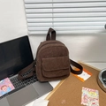 Minimalist brown corduroy backpack for women shown in a cozy everyday desk setting - Brown